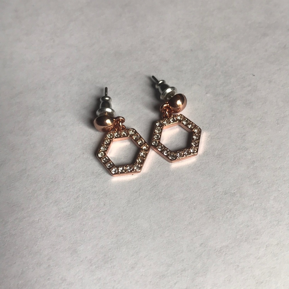 Copper colored earrings with small diamond studs